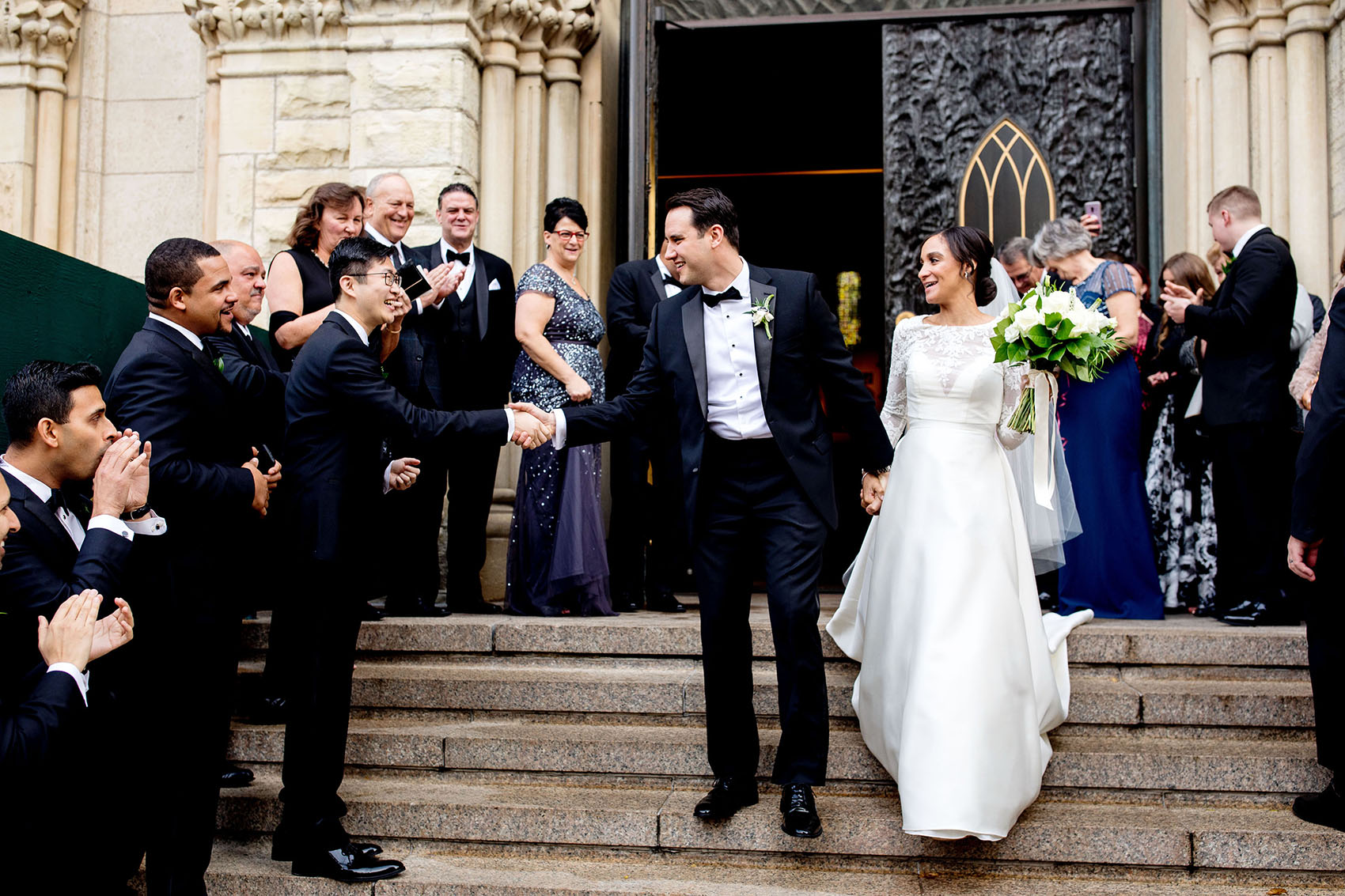 bride and groom exiting a holy name cathedral chicago wedding