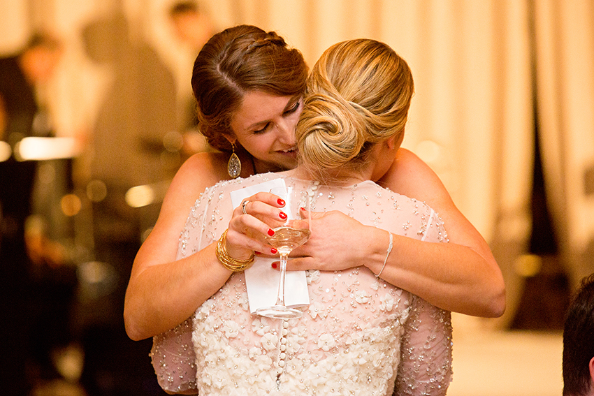 sisters hugging after a toast
